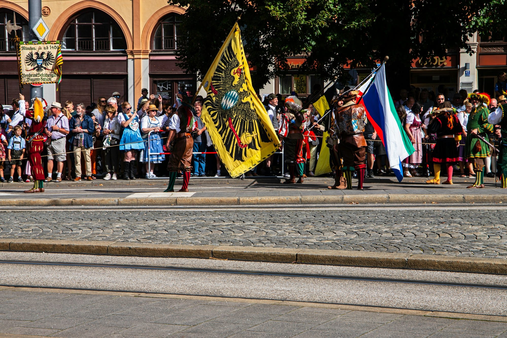 a group of people standing on the side of a road