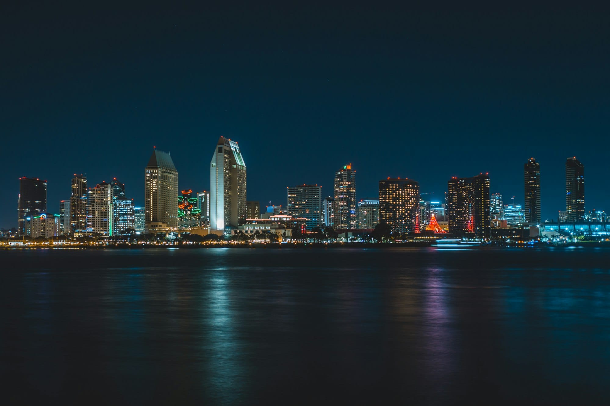 city near body of water during nighttime